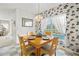 Quaint breakfast nook featuring cheerful wallpaper, natural light, and seating for four near the pool at 5516 Willow Bend Trl, Kissimmee, FL 34758