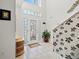 Welcoming foyer with tile flooring, decorative wallpaper, and staircase at 5516 Willow Bend Trl, Kissimmee, FL 34758