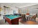 A fun game room including a pool table, a foosball table and a seating arrangement at 5516 Willow Bend Trl, Kissimmee, FL 34758