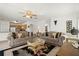 Open concept living area with comfortable couches, connecting to the dining and kitchen areas at 5516 Willow Bend Trl, Kissimmee, FL 34758