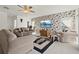 Spacious living room featuring a floral accent wall and cozy seating arrangement at 5516 Willow Bend Trl, Kissimmee, FL 34758