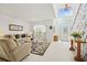 Open living area with neutral furniture, large window, and view of the front entrance at 5516 Willow Bend Trl, Kissimmee, FL 34758