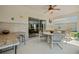 Covered patio features a ceiling fan, tile accents, and sliding glass doors to blend indoor and outdoor living at 5516 Willow Bend Trl, Kissimmee, FL 34758