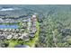 An aerial view showcases a community with single-Gathering homes nestled between water features and lush greenery at 722 Portofino Dr, Kissimmee, FL 34759