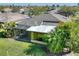 Backyard featuring a screened-in porch, lush landscaping, and ample green space, perfect for outdoor enjoyment at 722 Portofino Dr, Kissimmee, FL 34759