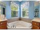 Bright bathroom featuring a large tub, decorative tile work, and ample natural light for a relaxing atmosphere at 722 Portofino Dr, Kissimmee, FL 34759