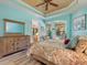Bright bedroom featuring wood-look floors, a ceiling fan, and stylish furniture, creating a cozy and inviting retreat at 722 Portofino Dr, Kissimmee, FL 34759