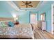 Bright bedroom featuring wood-look floors and a ceiling fan, creating a cozy and inviting space at 722 Portofino Dr, Kissimmee, FL 34759
