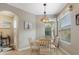 Cozy dining area with a round table, window, and arched doorway to the kitchen at 722 Portofino Dr, Kissimmee, FL 34759