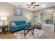 Cozy living room with hardwood floors, ceiling fan, and natural light at 722 Portofino Dr, Kissimmee, FL 34759