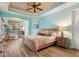 Tranquil main bedroom suite with tray ceiling and seating area at 722 Portofino Dr, Kissimmee, FL 34759