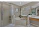 Bathroom boasts tiled floor and large tub with marble surround, ideal for relaxing at 723 Allison Ave, Davenport, FL 33897