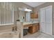 Bathroom featuring a luxurious tub, vanity with ample storage, and neutral decor at 723 Allison Ave, Davenport, FL 33897