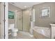 Modern bathroom features tiled floor, glass shower, toilet and stylish fixtures at 723 Allison Ave, Davenport, FL 33897