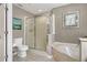 Bright bathroom featuring a separate tub and shower with updated fixtures at 723 Allison Ave, Davenport, FL 33897