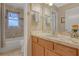 Bathroom featuring a vanity, framed mirror, and shower with tiled walls at 723 Allison Ave, Davenport, FL 33897