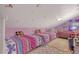 Charming bedroom with twin beds, whimsical decor, and vaulted ceiling at 723 Allison Ave, Davenport, FL 33897