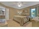 Comfortable bedroom featuring neutral walls, a ceiling fan, and views of the attached bathroom at 723 Allison Ave, Davenport, FL 33897