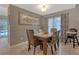 Dining area with a modern light fixture and window at 723 Allison Ave, Davenport, FL 33897