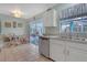 Bright kitchen featuring tile floors, stainless steel appliances, and access to the screened patio at 723 Allison Ave, Davenport, FL 33897