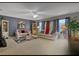 Cozy living room with large windows, neutral carpeting, and comfortable seating at 723 Allison Ave, Davenport, FL 33897