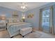 Serene main bedroom with a large window, soft lighting, and plush bedding at 723 Allison Ave, Davenport, FL 33897