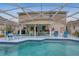 Spacious screened-in pool area with plenty of patio seating, perfect for outdoor entertaining and relaxation at 723 Allison Ave, Davenport, FL 33897
