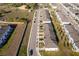 Aerial view featuring a well-maintained community with townhomes, manicured landscaping, and ample parking at 728 Madison Dr, Davenport, FL 33837