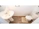 Cozy powder room with a pedestal sink, wood-look floors, and a convenient toilet at 728 Madison Dr, Davenport, FL 33837