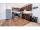 Kitchen featuring dark cabinets, stainless steel appliances, and granite countertops at 728 Madison Dr, Davenport, FL 33837