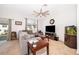 Inviting living room with neutral carpet, ceiling fan, and a large window for ample natural light at 728 Madison Dr, Davenport, FL 33837