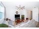Spacious living room featuring neutral tones, a ceiling fan, and seamless transition to other living areas at 728 Madison Dr, Davenport, FL 33837