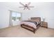 Bedroom with a ceiling fan, natural light from the window, and neutral decor at 728 Madison Dr, Davenport, FL 33837