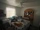 This is a cluttered bedroom featuring a ceiling fan, bed, and lots of personal belongings at 731 Trenton Rd, Lakeland, FL 33815
