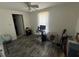 Bedroom with gray wood-look floors, white walls, and ceiling fan at 731 Trenton Rd, Lakeland, FL 33815