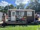 Quaint home exterior with a cozy porch and well-maintained lawn, with plants and flowers at 731 Trenton Rd, Lakeland, FL 33815