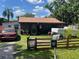 Charming single-story home with a screened porch, surrounded by a fenced yard at 731 Trenton Rd, Lakeland, FL 33815