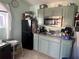 Practical kitchen with green cabinets, black appliances, and a sink with a window at 731 Trenton Rd, Lakeland, FL 33815