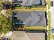 Aerial view of a home with a dark roof, screened-in lanai, and well-maintained lawn, outlined in red at 7412 Soiree Way, Reunion, FL 34747