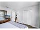 Bedroom featuring hardwood floors, large closet doors and view into another room at 7412 Soiree Way, Reunion, FL 34747