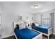 Bedroom featuring hardwood floors and two twin beds, each with a nightstand at 7412 Soiree Way, Reunion, FL 34747