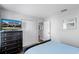 Cozy bedroom with a closet and dresser, featuring neutral walls and blue bedding at 7412 Soiree Way, Reunion, FL 34747