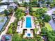 An aerial view of the community pool area featuring a large pool, lounge chairs, and manicured landscaping at 7412 Soiree Way, Reunion, FL 34747