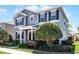 Beautiful two-story home showcases lush landscaping and a welcoming entrance at 7412 Soiree Way, Reunion, FL 34747