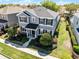 Charming two-story house boasts neat landscaping and a welcoming front porch with dark shutters at 7412 Soiree Way, Reunion, FL 34747