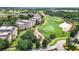 Aerial view of a golf course with winding paths between apartment buildings and landscaped greenery at 7412 Soiree Way, Reunion, FL 34747