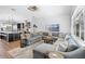 Open-concept living room and kitchen with a large sectional and luxury finishes at 7412 Soiree Way, Reunion, FL 34747