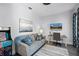 Inviting living room featuring a comfortable sofa, a desk and TV, and a classic arcade game at 7412 Soiree Way, Reunion, FL 34747