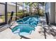 Private screened-in pool and hot tub with views of surrounding greenery at 7412 Soiree Way, Reunion, FL 34747