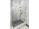 Elegant glass shower featuring marble-style tile walls and stylish fixtures at 7412 Soiree Way, Reunion, FL 34747